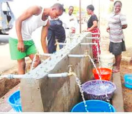 group of people fetching water