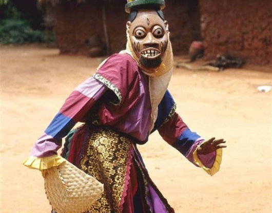 person with tribal mask and outfit